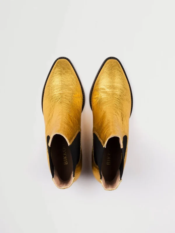 Goldene vegane Lederstiefel